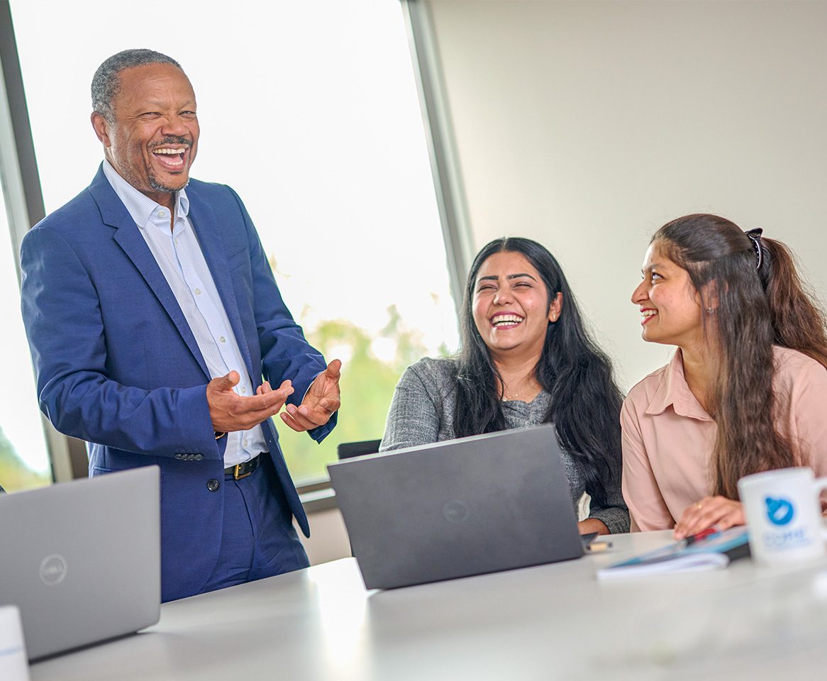 Team members sharing a light-hearted moment during a collaborative meeting.