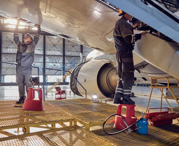 Aircraft engineers working on an airplane wing