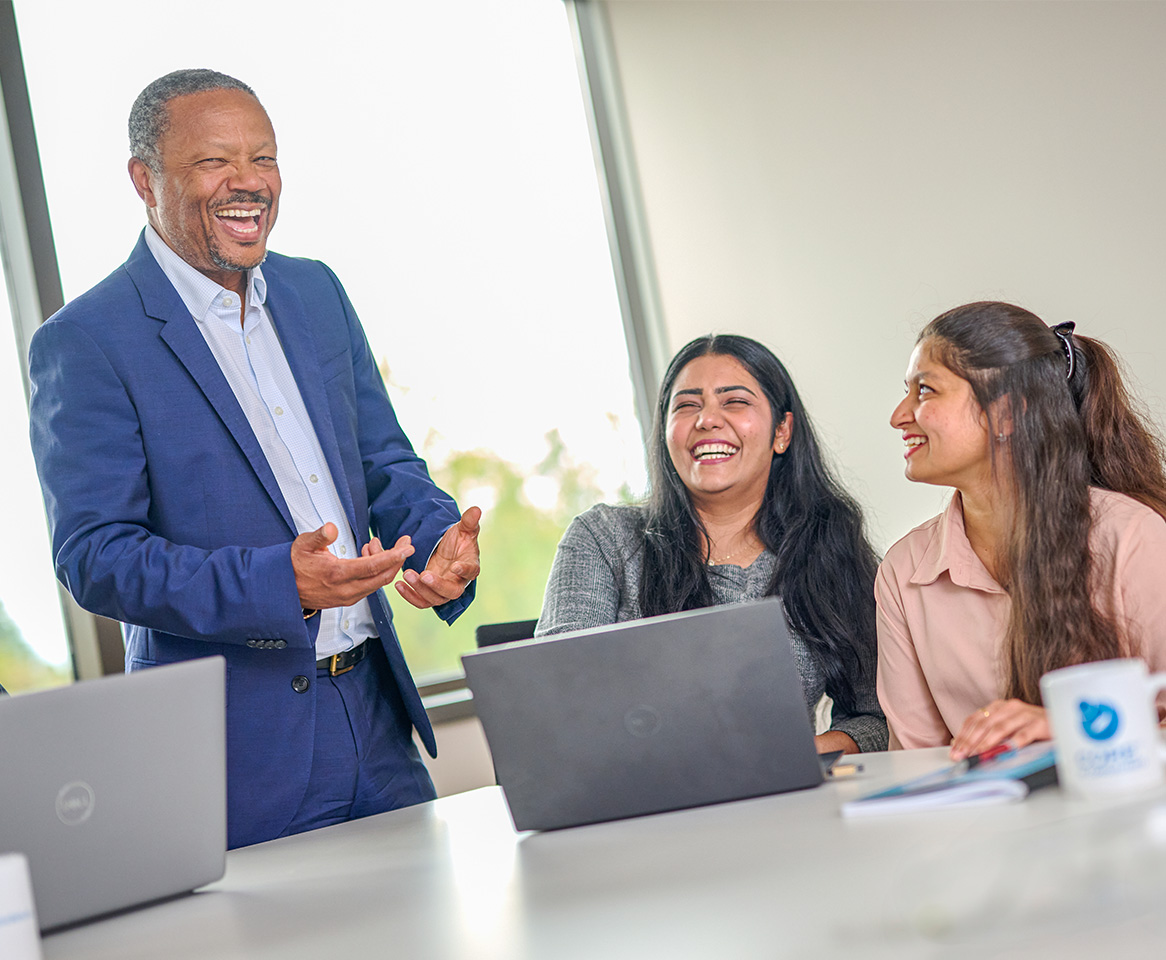 Team members sharing a light-hearted moment during a collaborative meeting.
