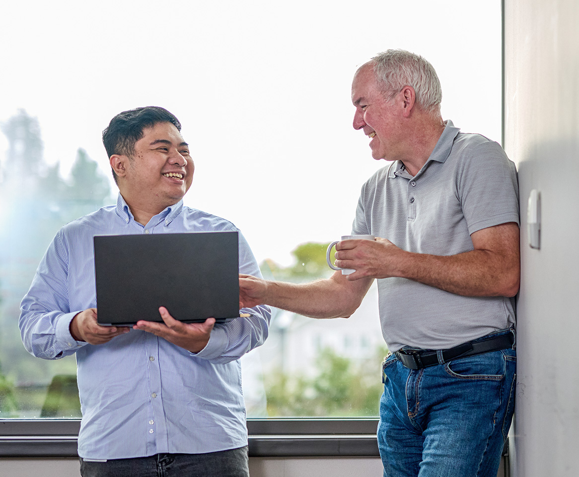 Two coworkers enjoying working together